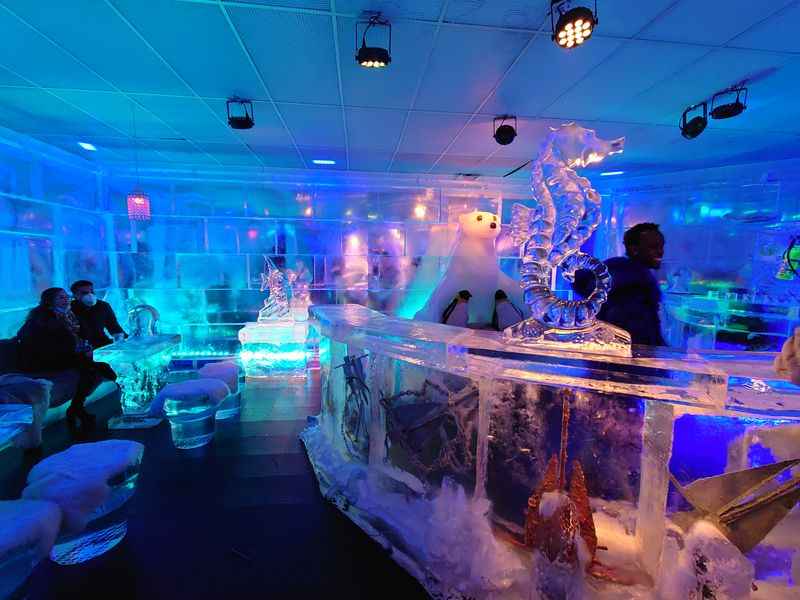 a bar with table and walls made of ice