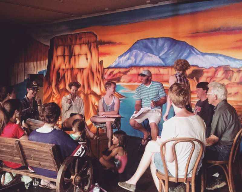 a group of people sitting at tables in a restaurant