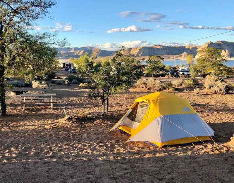 a tent in the desert with mountains in the background