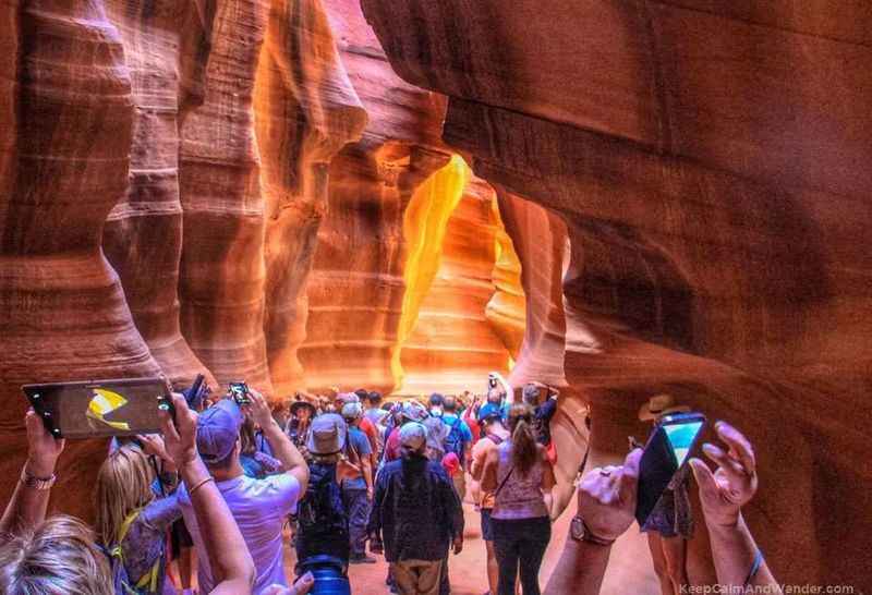 people taking pictures of the slot canyon