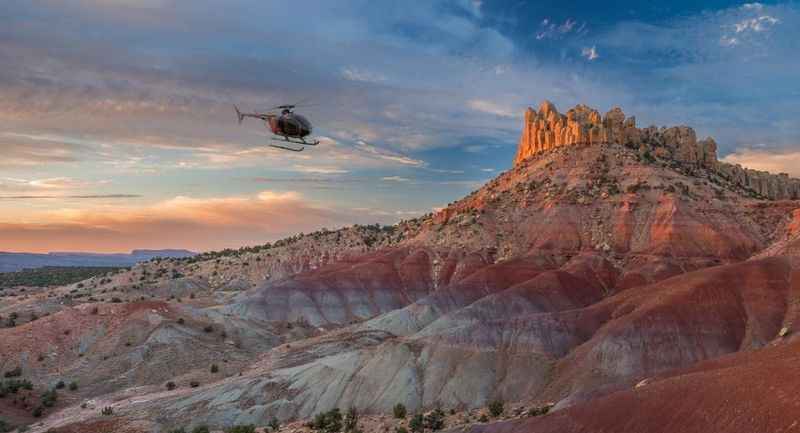 a helicopter flying over a rocky landscape