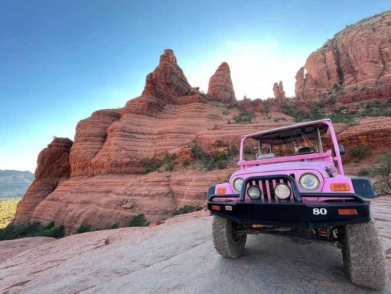 a jeep parked on a rock in the desert