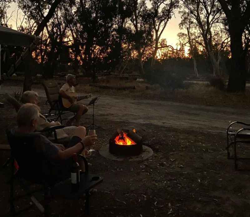 people sitting around a fire in the bush