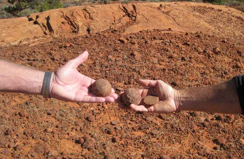 two persons holding a rock in their hand