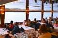 people sitting at tables in a restaurant of a cruise