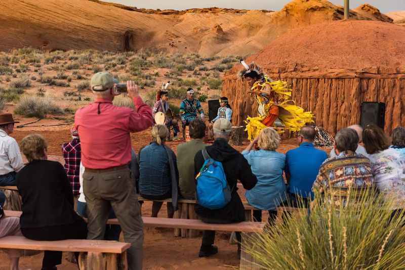 people sitting on benches in the desert