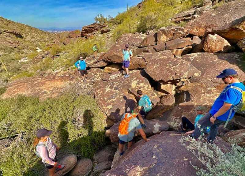 a group of people climbing up a rocky mountain