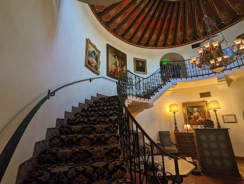 a staircase with a beautiful chandel