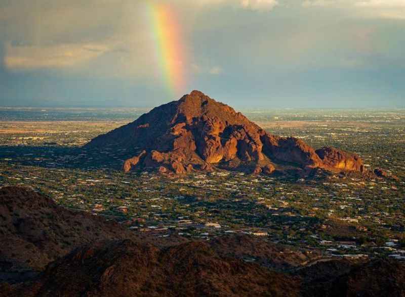 breathtaking view of mountain with rainbow over it