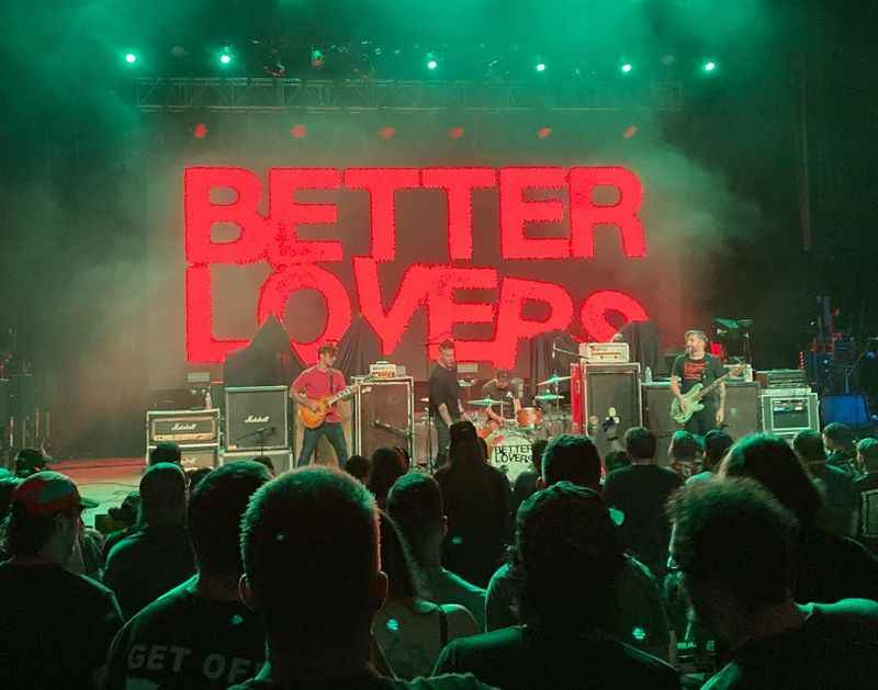 people on the stage holding guitars and playing music