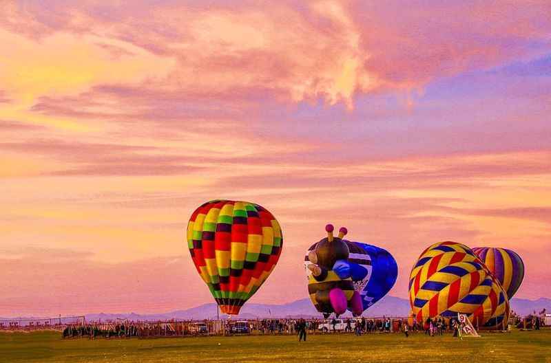 Three beautiful hot air balloons under the pink sky