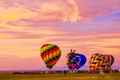 Three beautiful hot air balloons under the pink sky