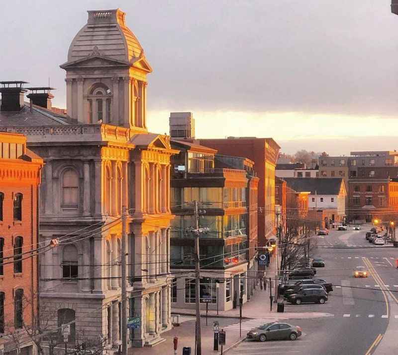 a view of a city street with buildings on a sunset