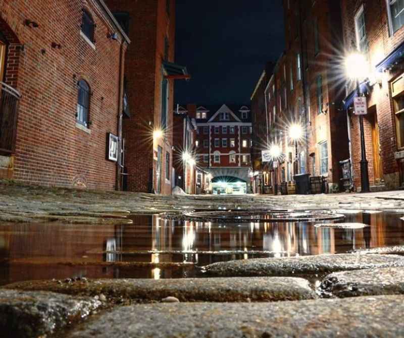 a puddle in the middle of a street at night