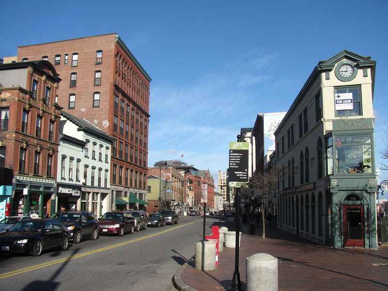 a street with a clock on top of the building 