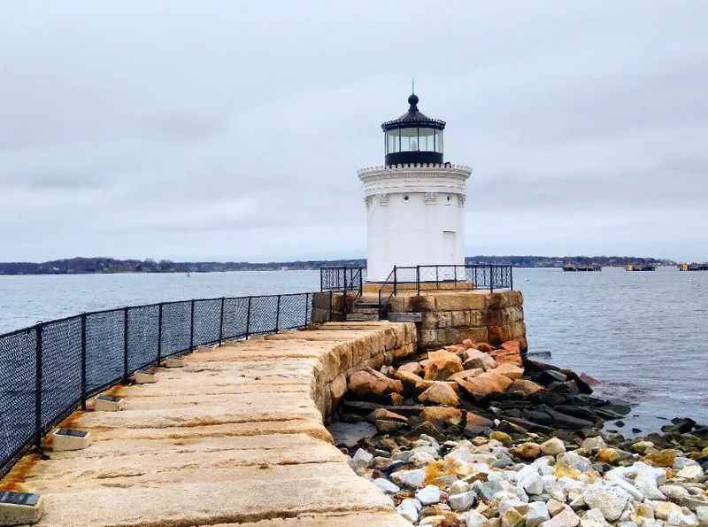 a lighthouse on the shore of a body of water