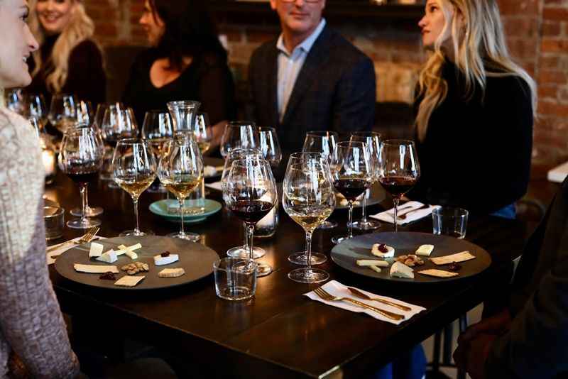 people sitting at a table with wine glasses