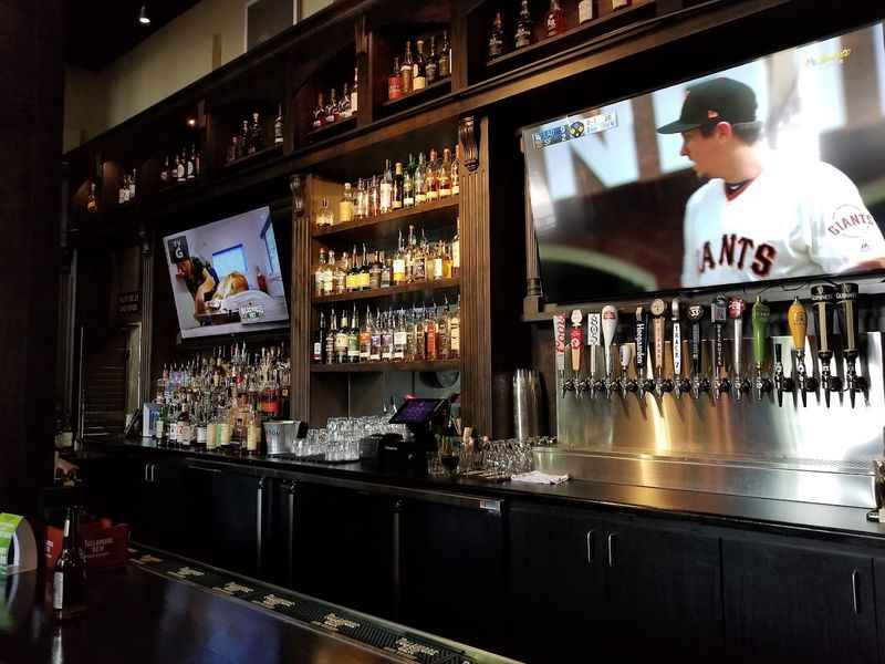 a bar with a television on the wall