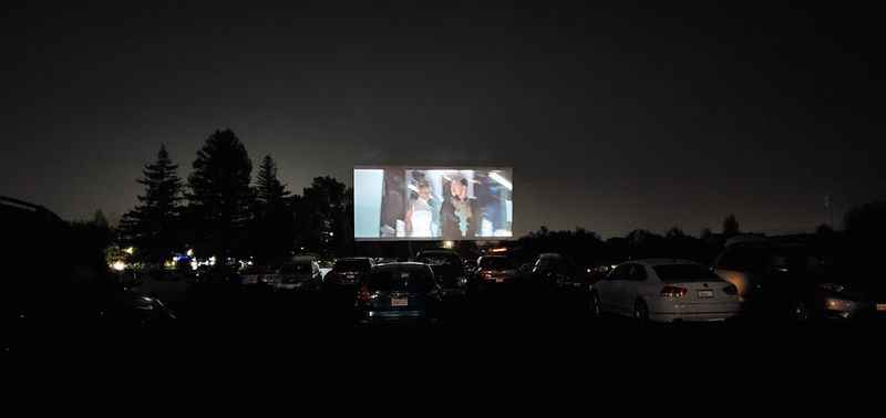 a large screen is lit up in the dark