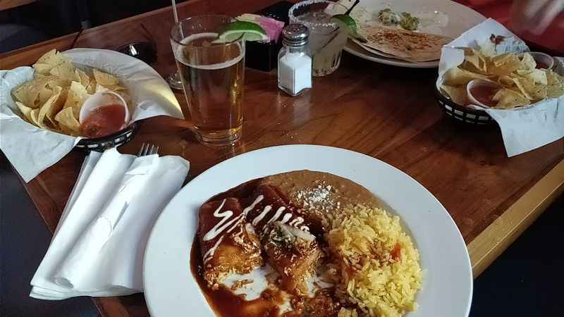 a table with a plate of food and drinks