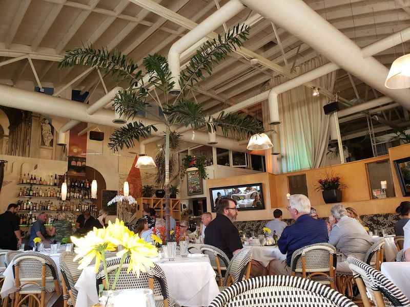 a restaurant with people sitting at tables and eating