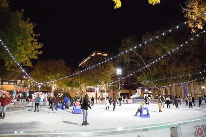 a group of people skating on a rink