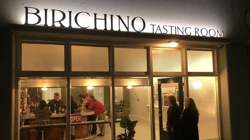 a group of people standing outside of Tasting room