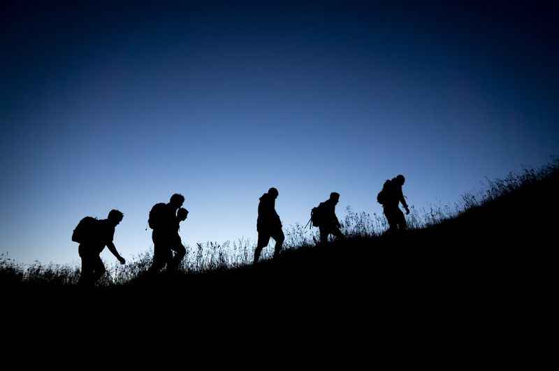 a group of people walking up a hill