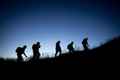 a group of people walking up a hill