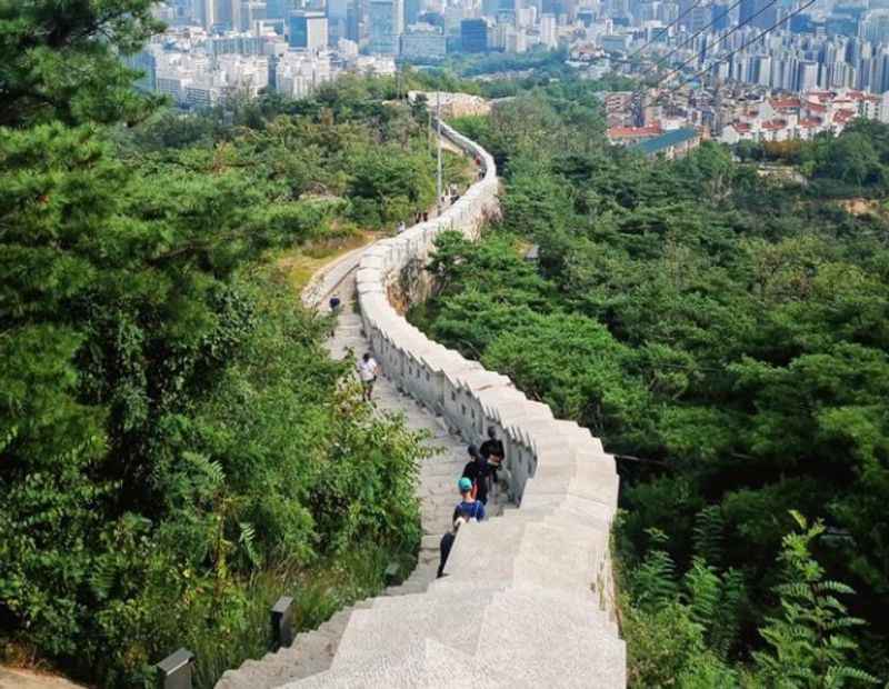 the view from the top of the mountain with man made wall