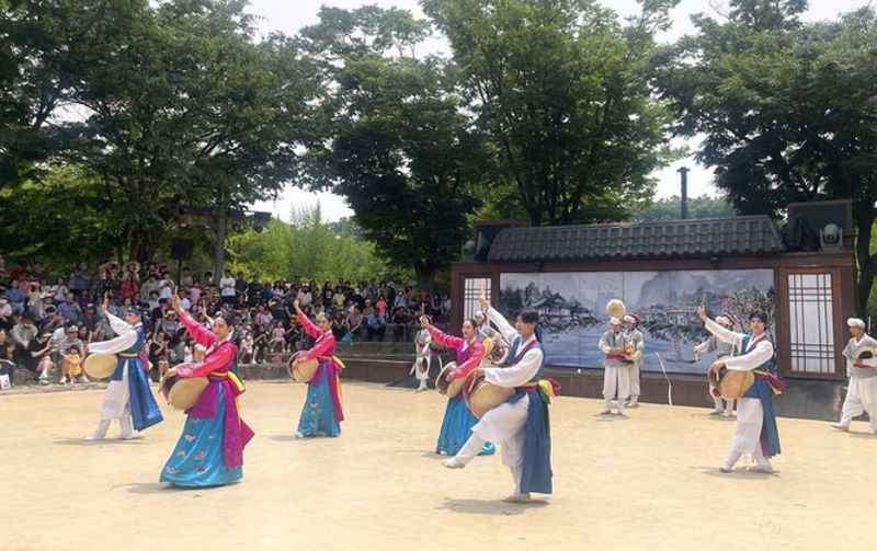 a group of people in traditional costumes performing a dance