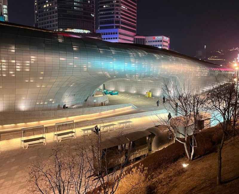 a large building with a glass roof at night