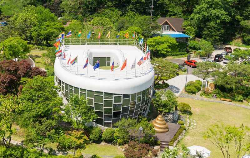 a toilet designed museum surrounded by trees