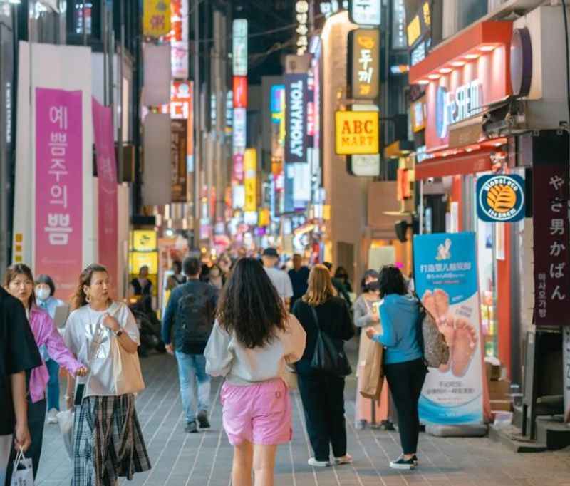 people walking down a street in Korea