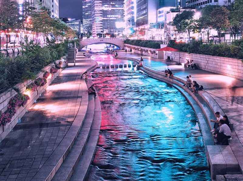 a river with a fountain in the middle of it