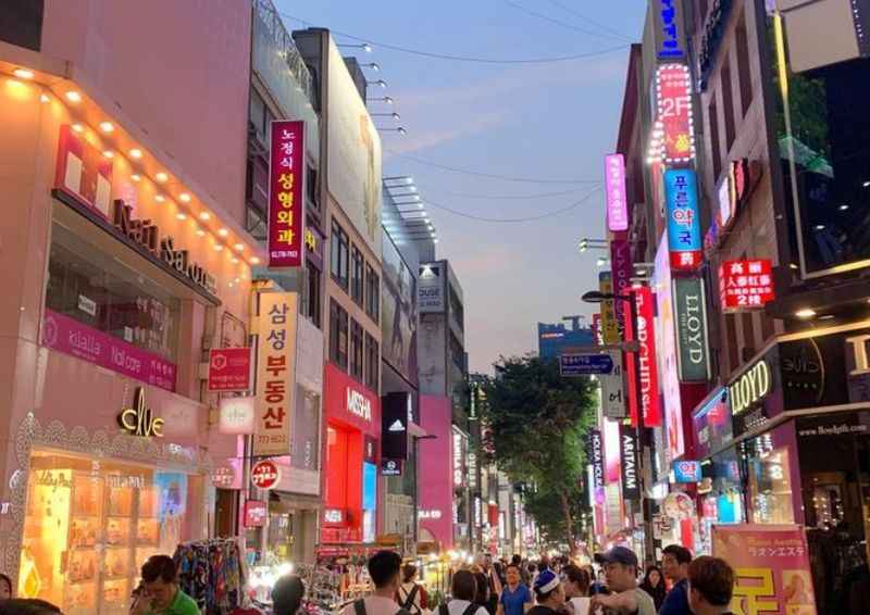 a busy street in the city of Korea at dusk