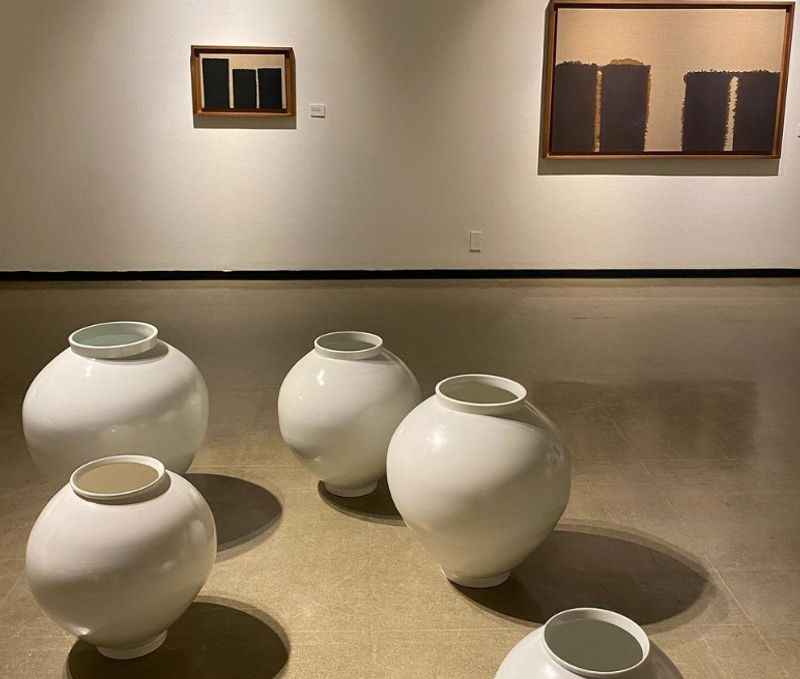 a group of white vases sitting on a floor