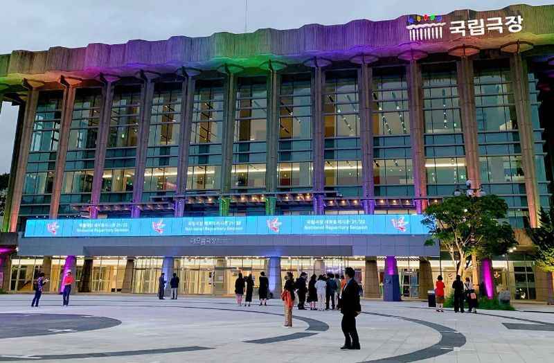 colorful facade of the building with people in front