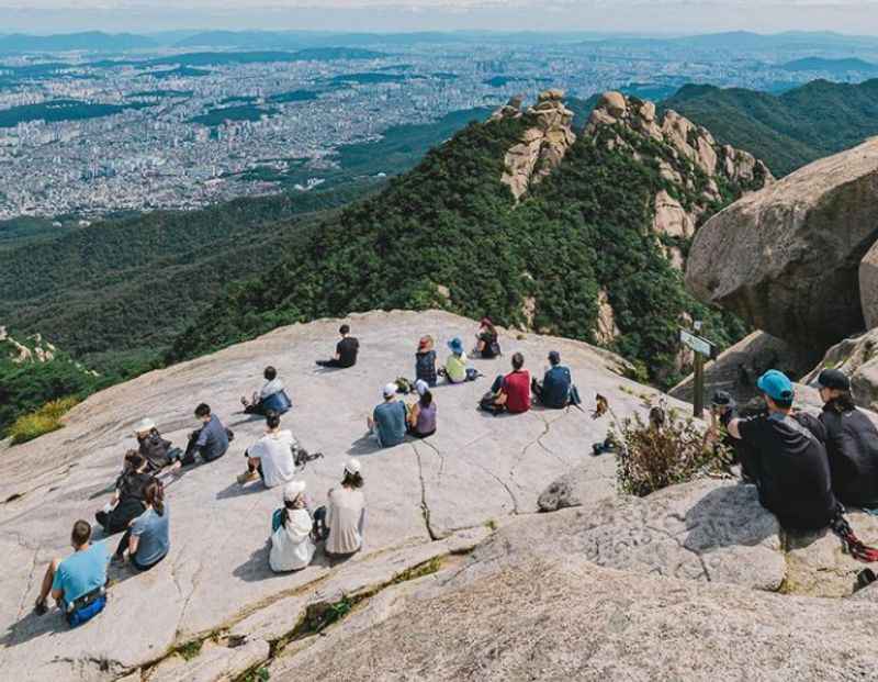 people sitting on top of a mountain