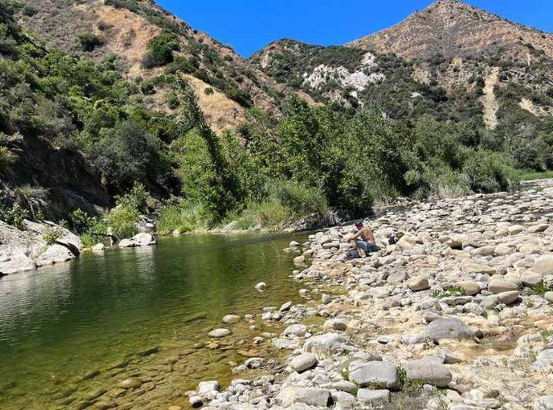 a man is wadi down a river in the mountains