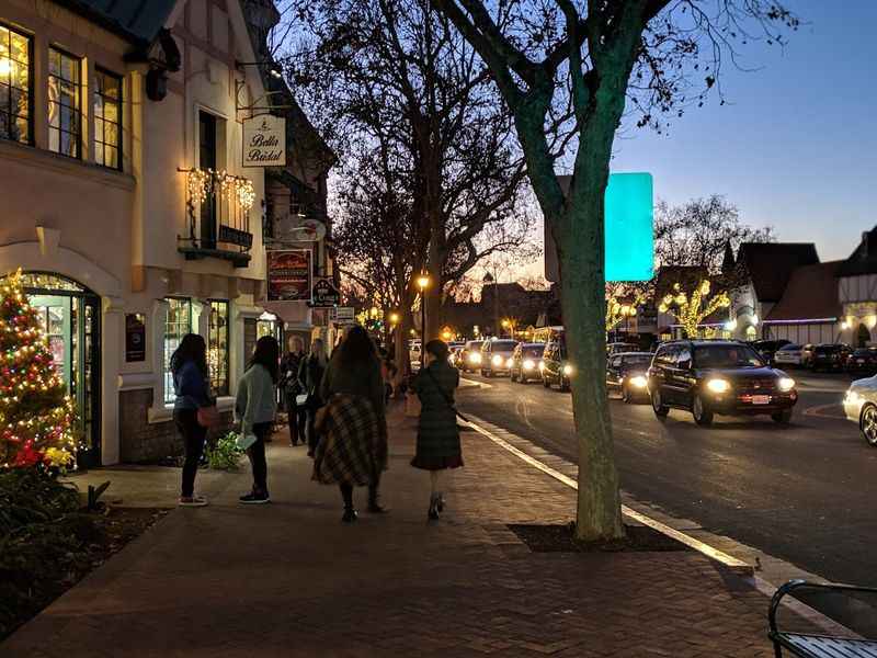 a couple of people walking down a street