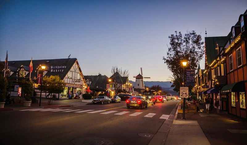 a street with cars parked on it at dusk