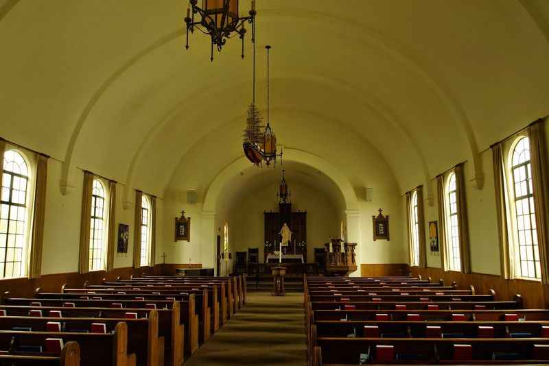 a church with a chandel hanging from the ceiling