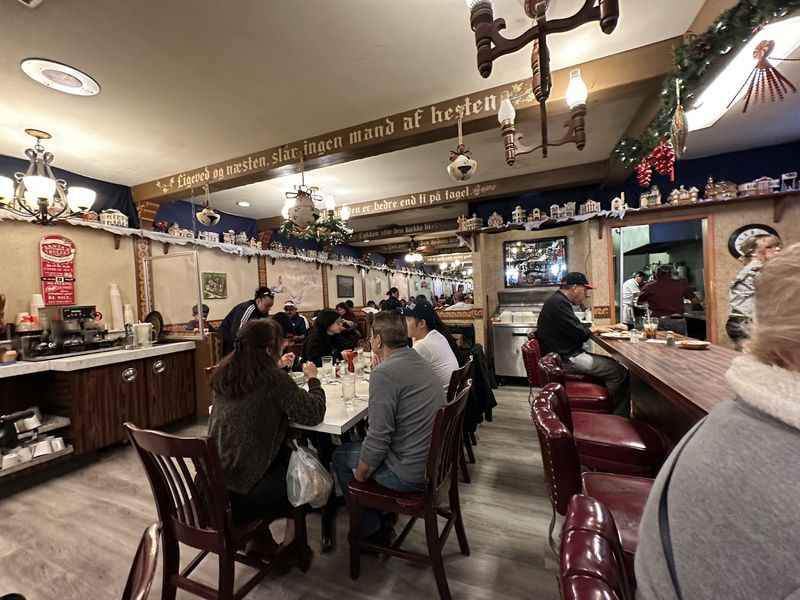 a group of people sitting at a table in a restaurant