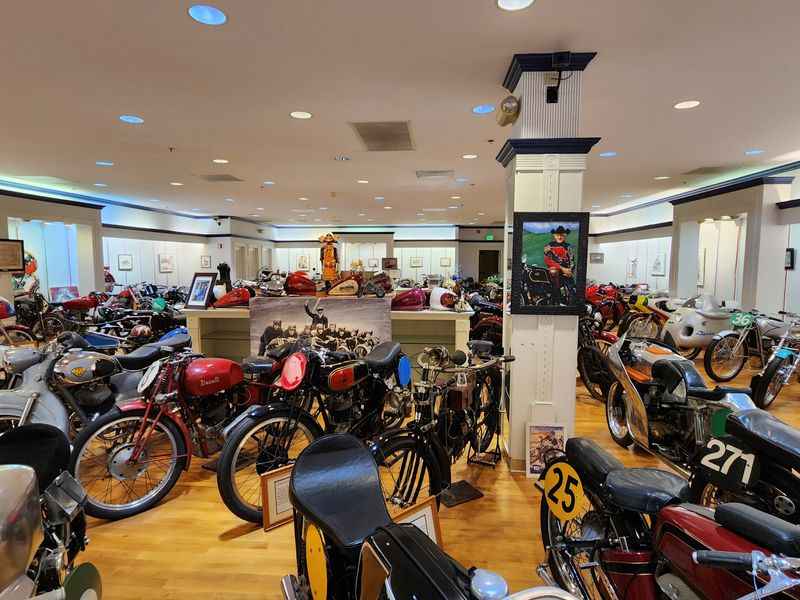a room filled with motorcycles and a man in a suit