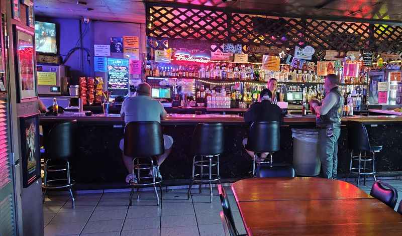 a bar with a man sitting at a table