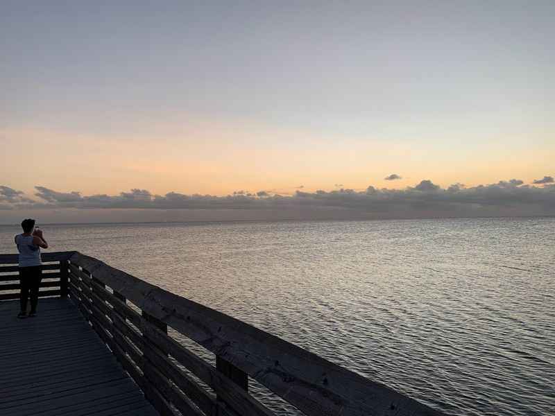 a person on a dock looking out at the ocean