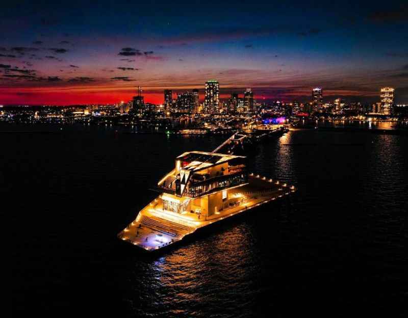 a boat is seen at night in the water