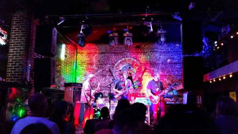 a band playing on stage in a bar