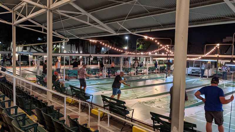 a group of people playing a game of ping - pong